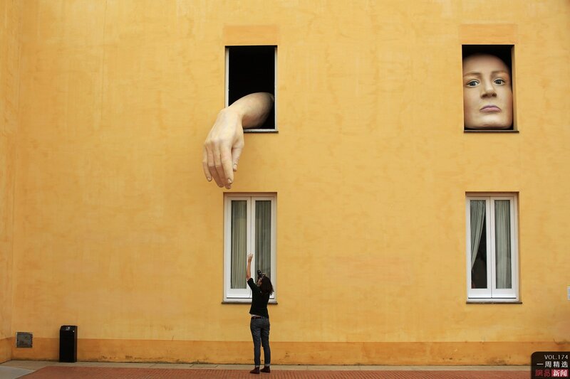 Person photographing art installation