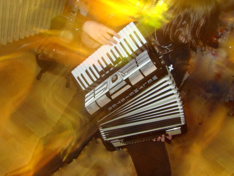 Person Playing Accordion — Yellow