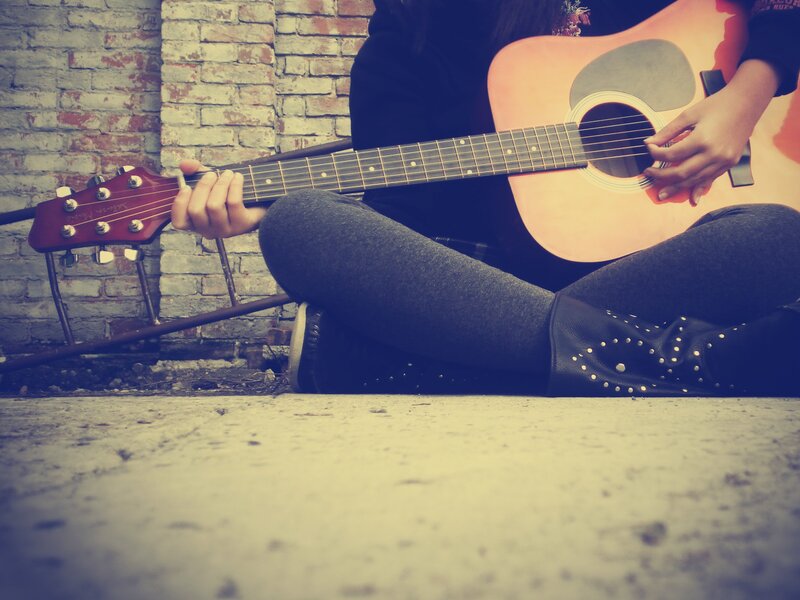 person playing acoustic guitar
