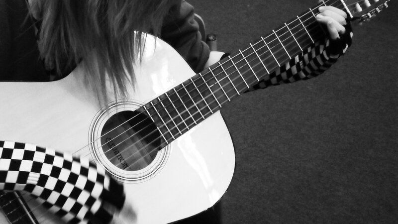 person playing acoustic guitar