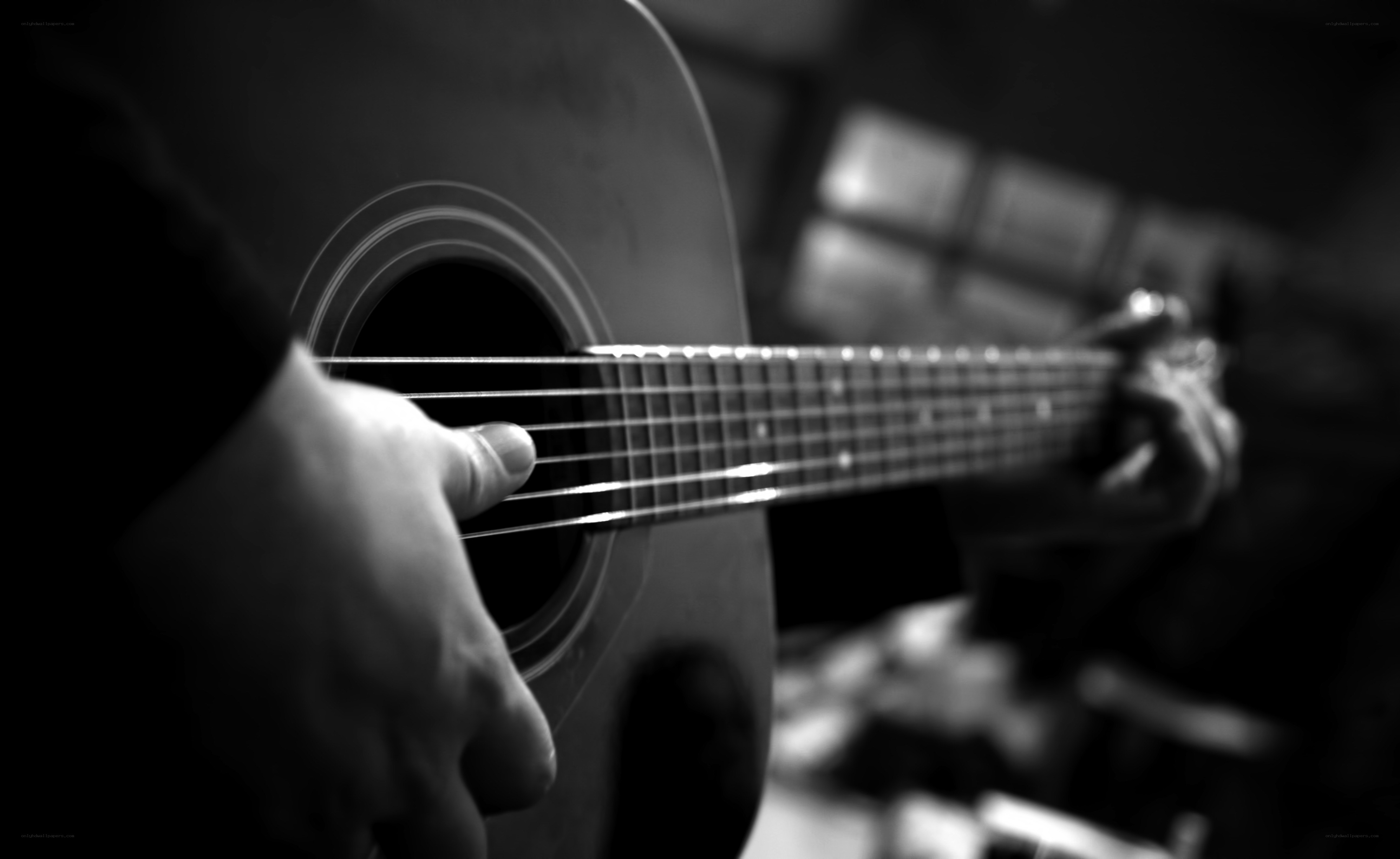 person playing acoustic guitar