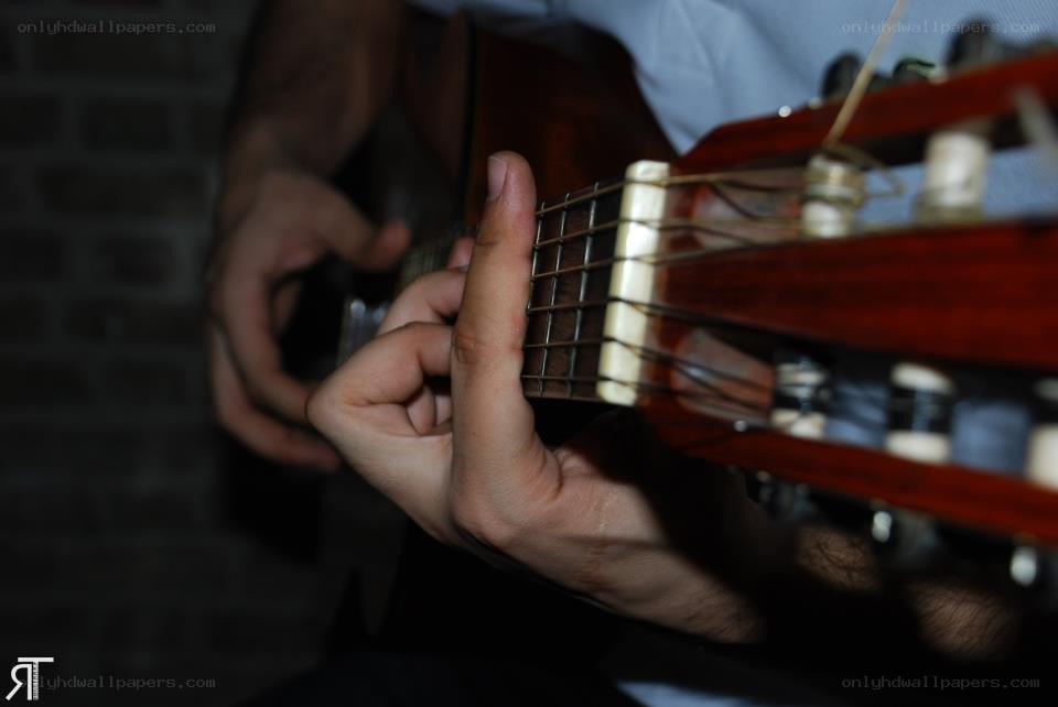 person playing acoustic guitar