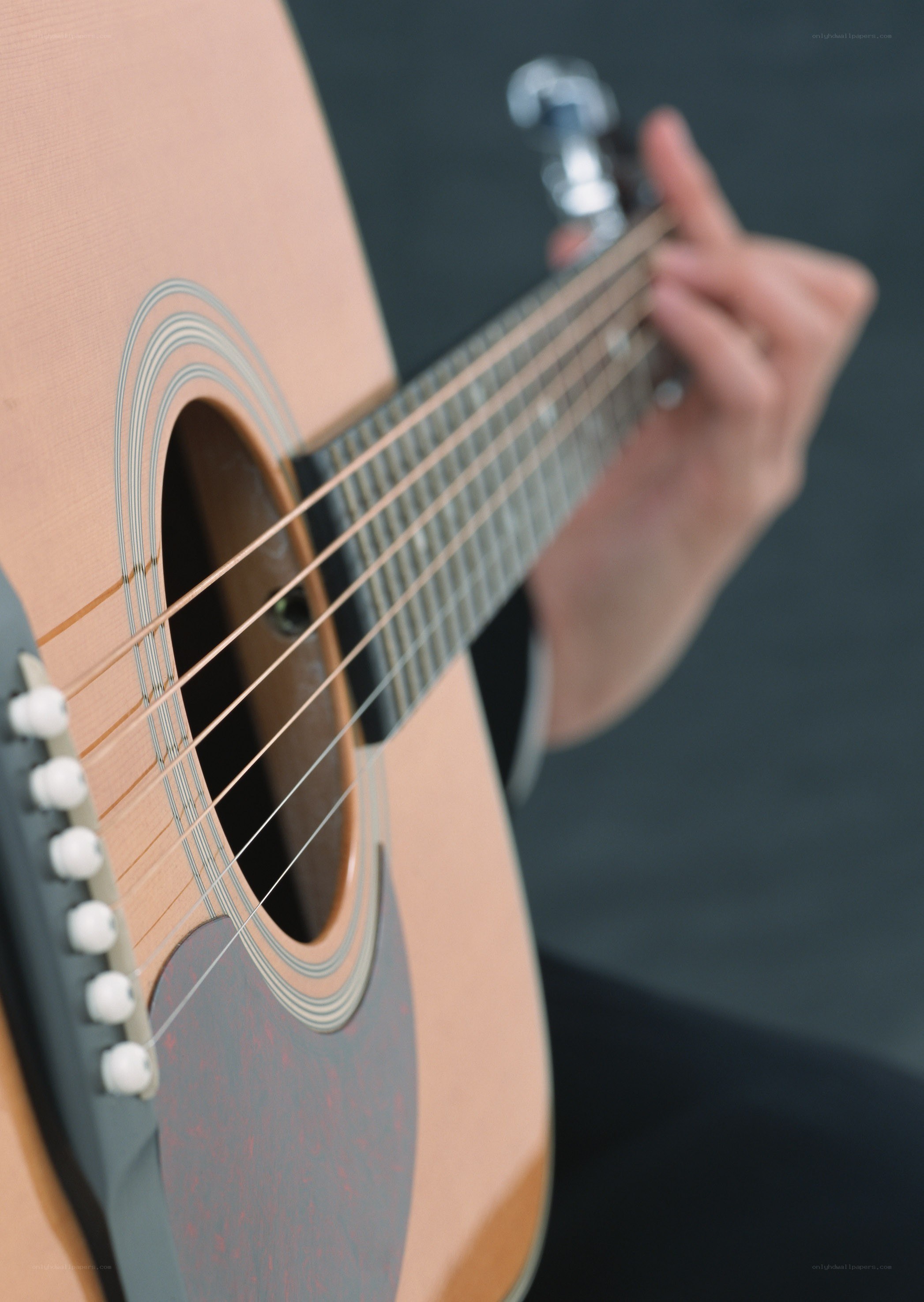 person playing acoustic guitar
