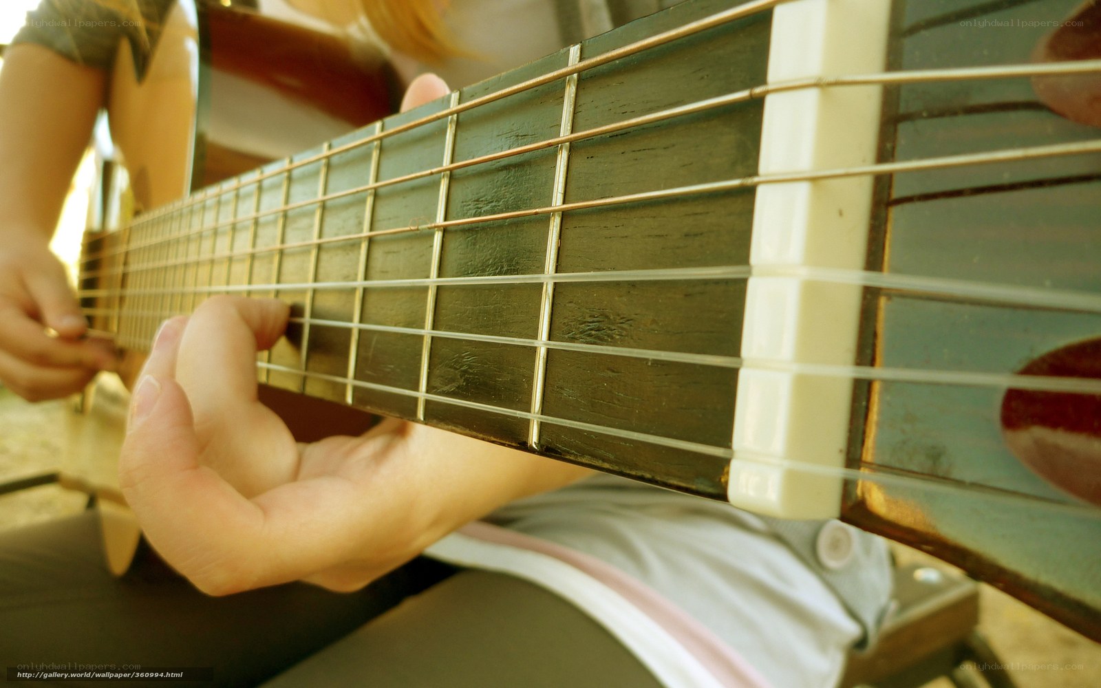 person playing acoustic guitar