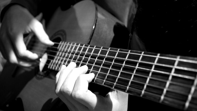 person playing acoustic guitar