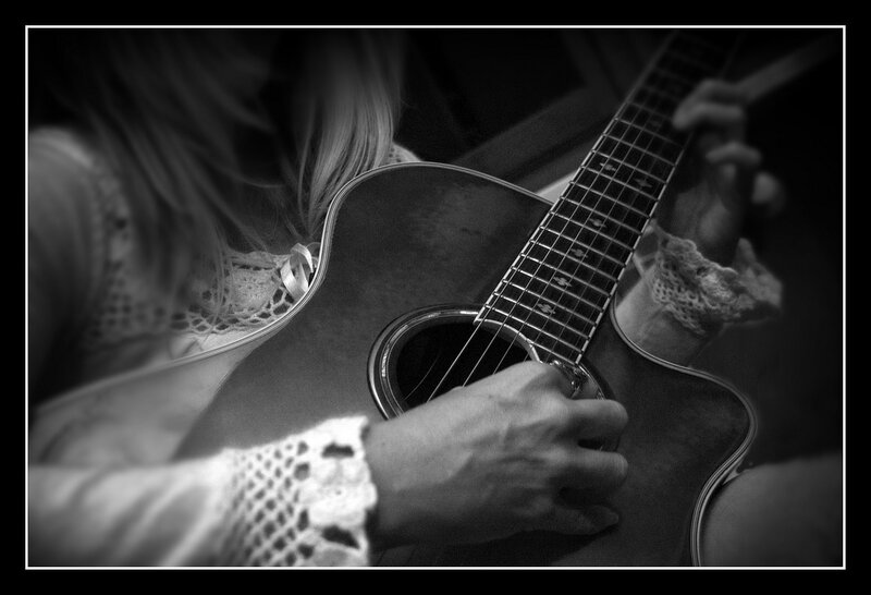 Person Playing Acoustic Guitar — Black
