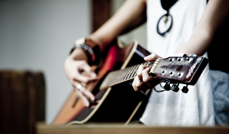 Person Playing Acoustic Guitar — White