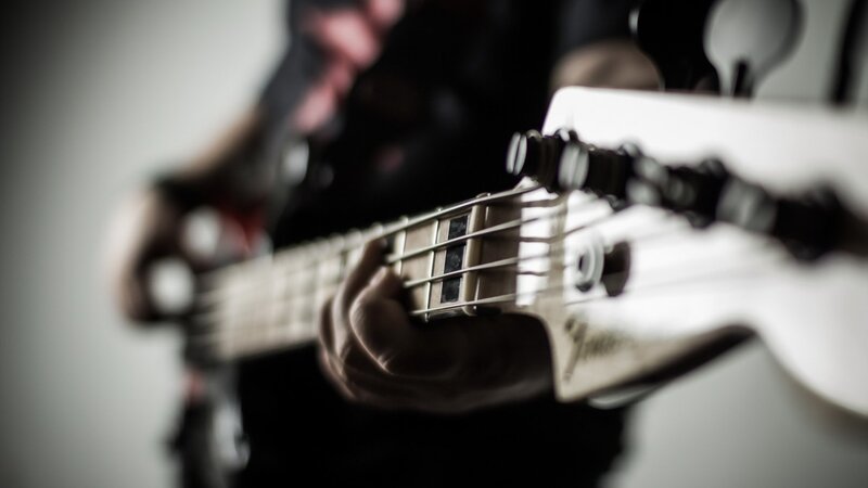 person playing bass guitar