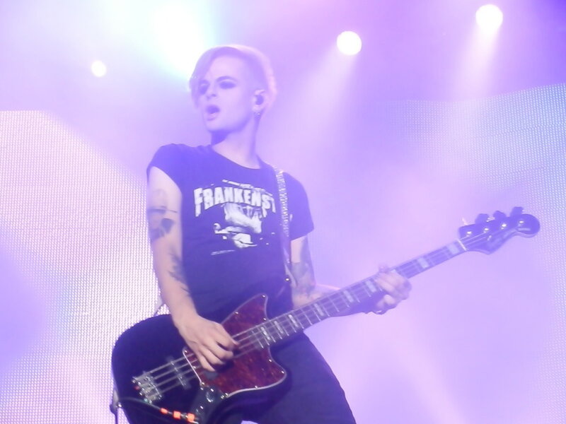 Person Playing Bass Guitar — Purple