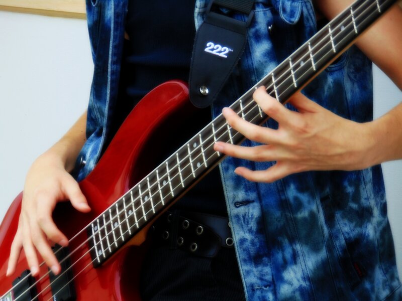 Person Playing Bass Guitar — Red