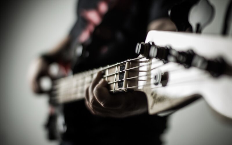 Person Playing Bass Guitar — White