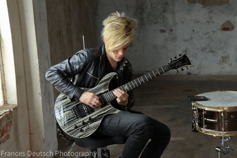 Person Playing Electric Guitar — Black, Focused
