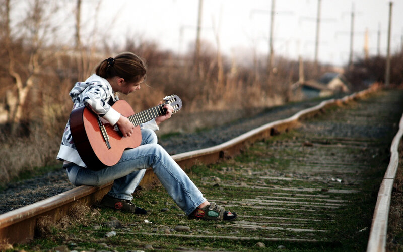 Person Playing Guitar — Brown, Contemplative