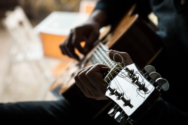 Person Playing Guitar — Brown, Focused