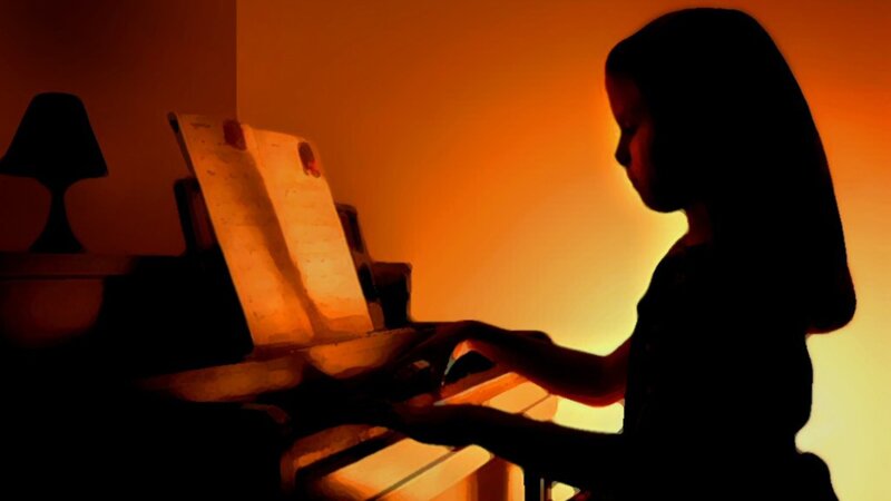 person playing piano at sunset