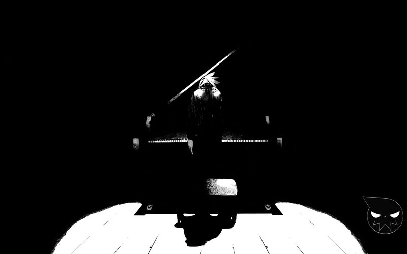 person playing piano in dark room