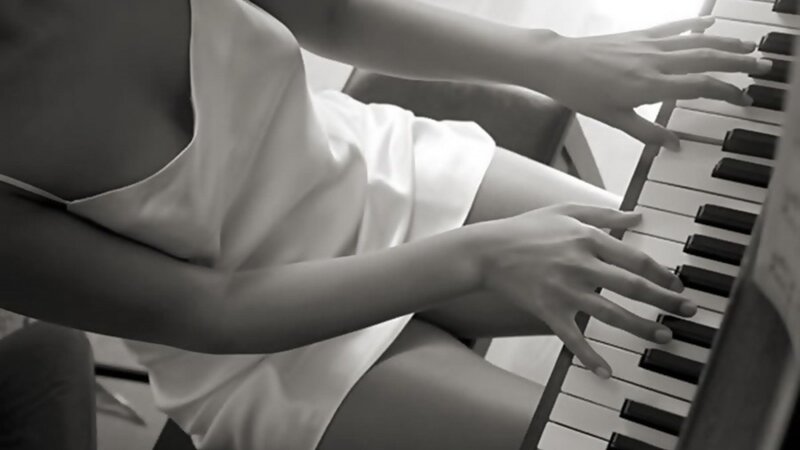 person playing piano in white dress