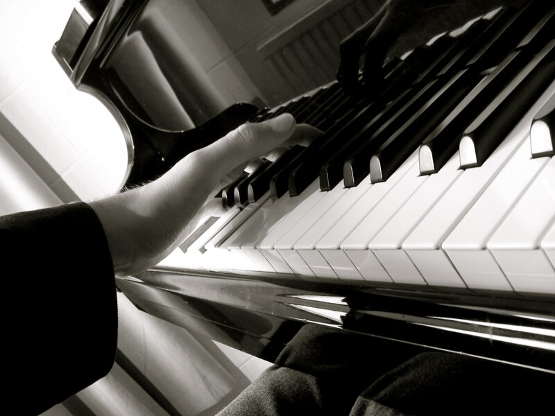 person playing piano keys