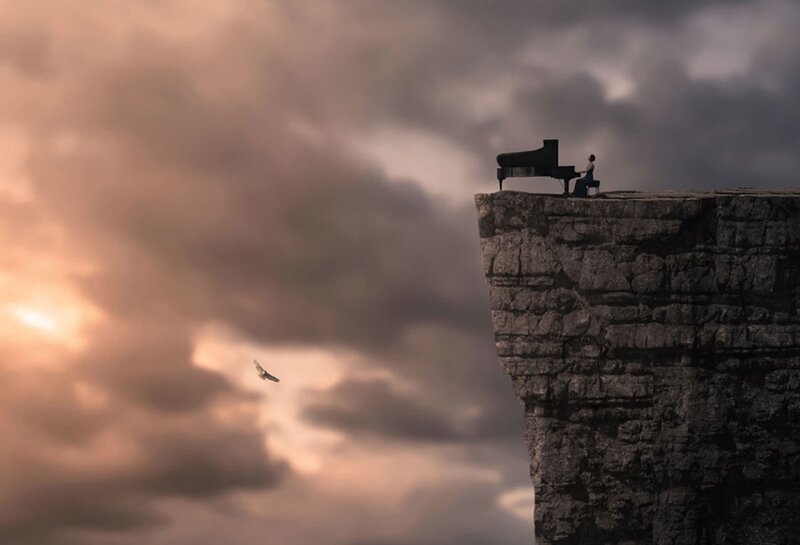Person Playing Piano on Cliff