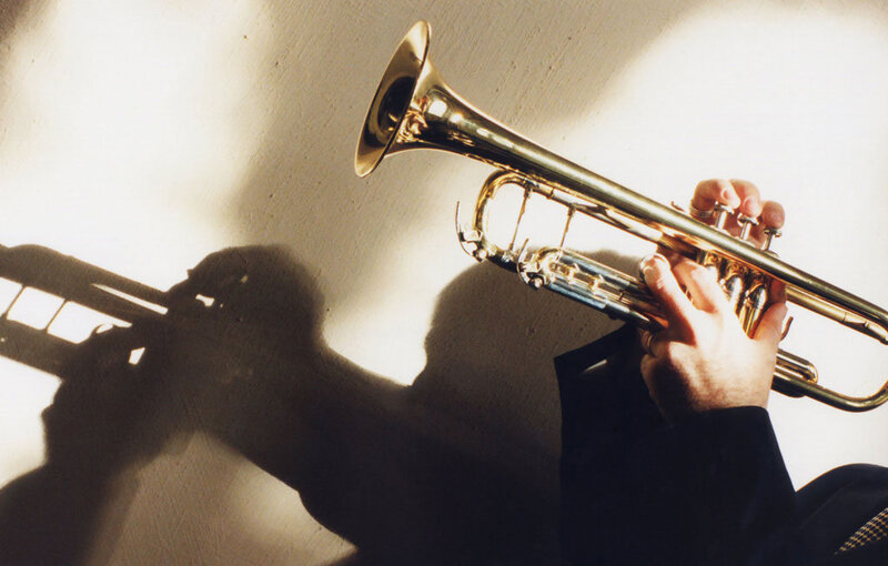 Person Playing Trumpet — Gold