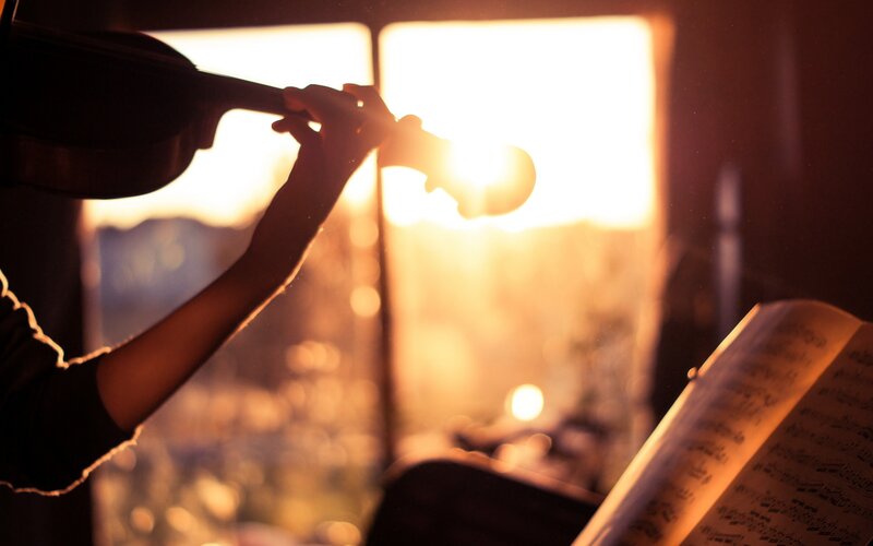 Person Playing Violin — Orange