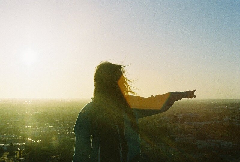person pointing at cityscape
