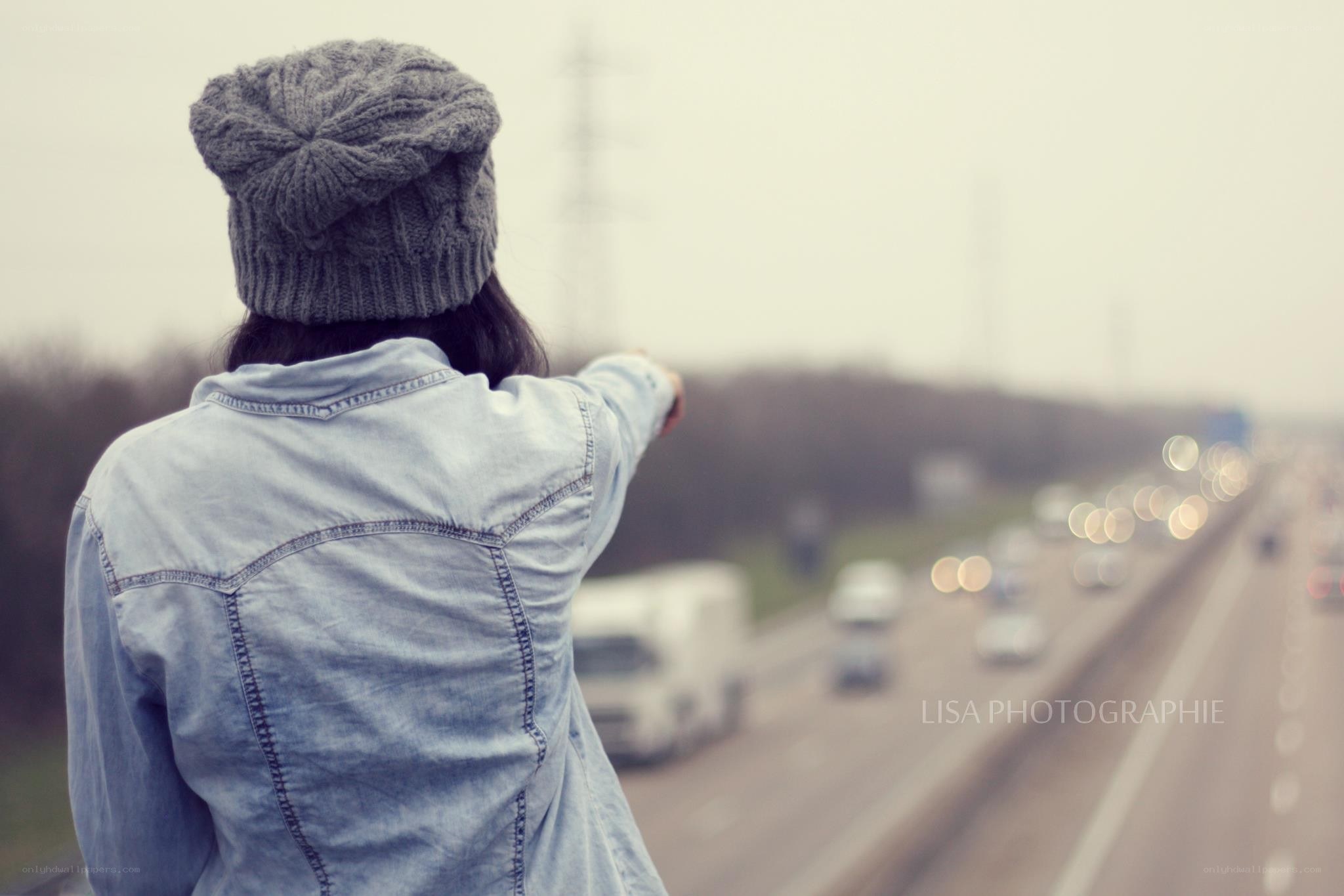 person pointing at highway