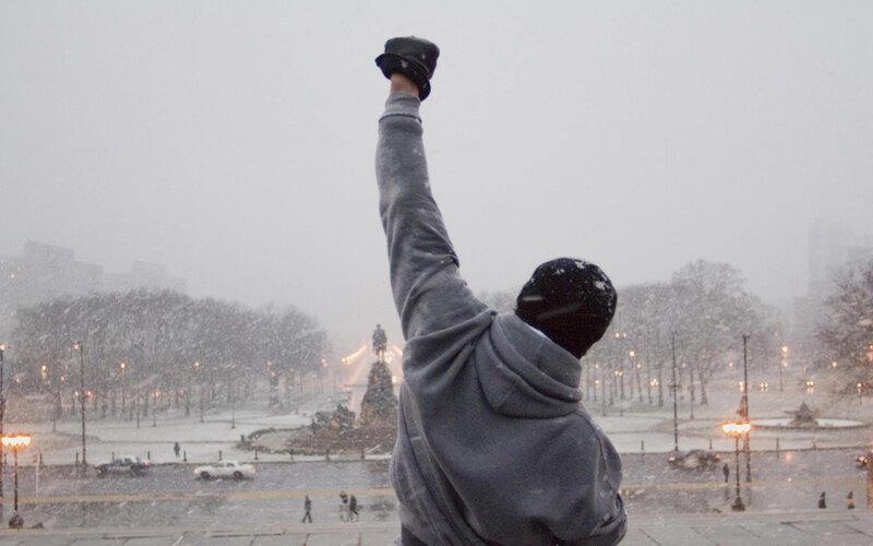 person raising fist in snow