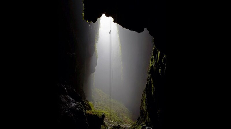 Person Rappelling in Cave — Black, Dramatic, Photograph, Light Beam, Rope