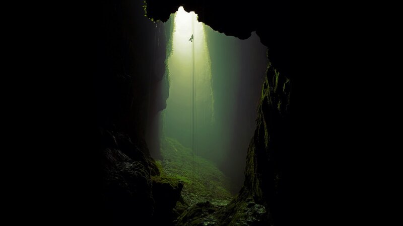 Person Rappelling in Cave — Black, Dramatic, Photograph, Light Beam