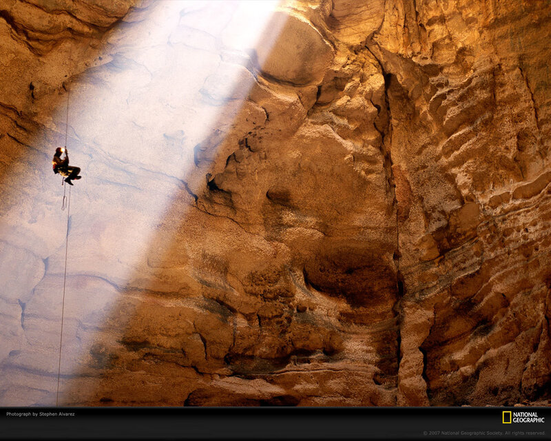 Person Rappelling in Cave