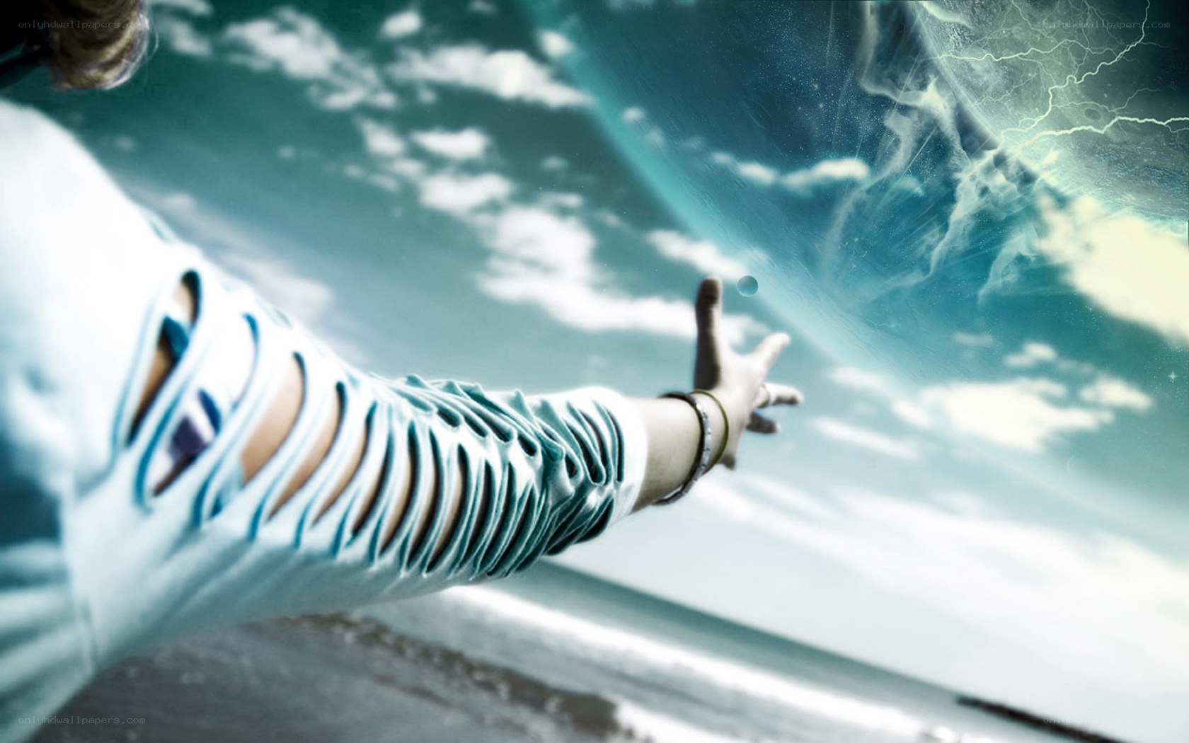 person reaching for a planet