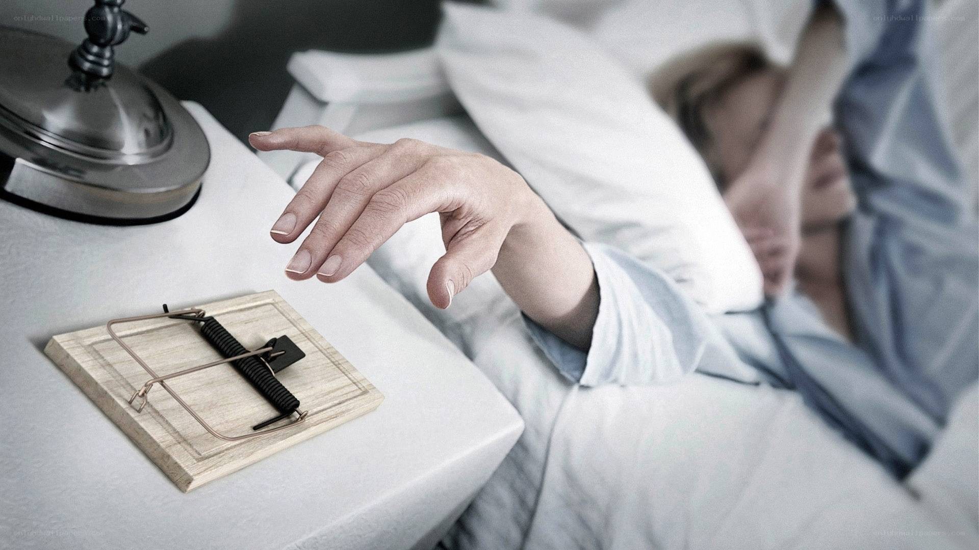 person reaching for mouse trap
