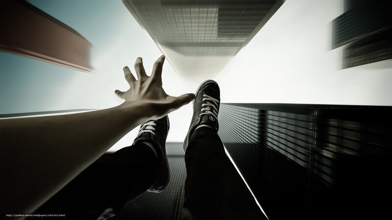 Person reaching up from high building