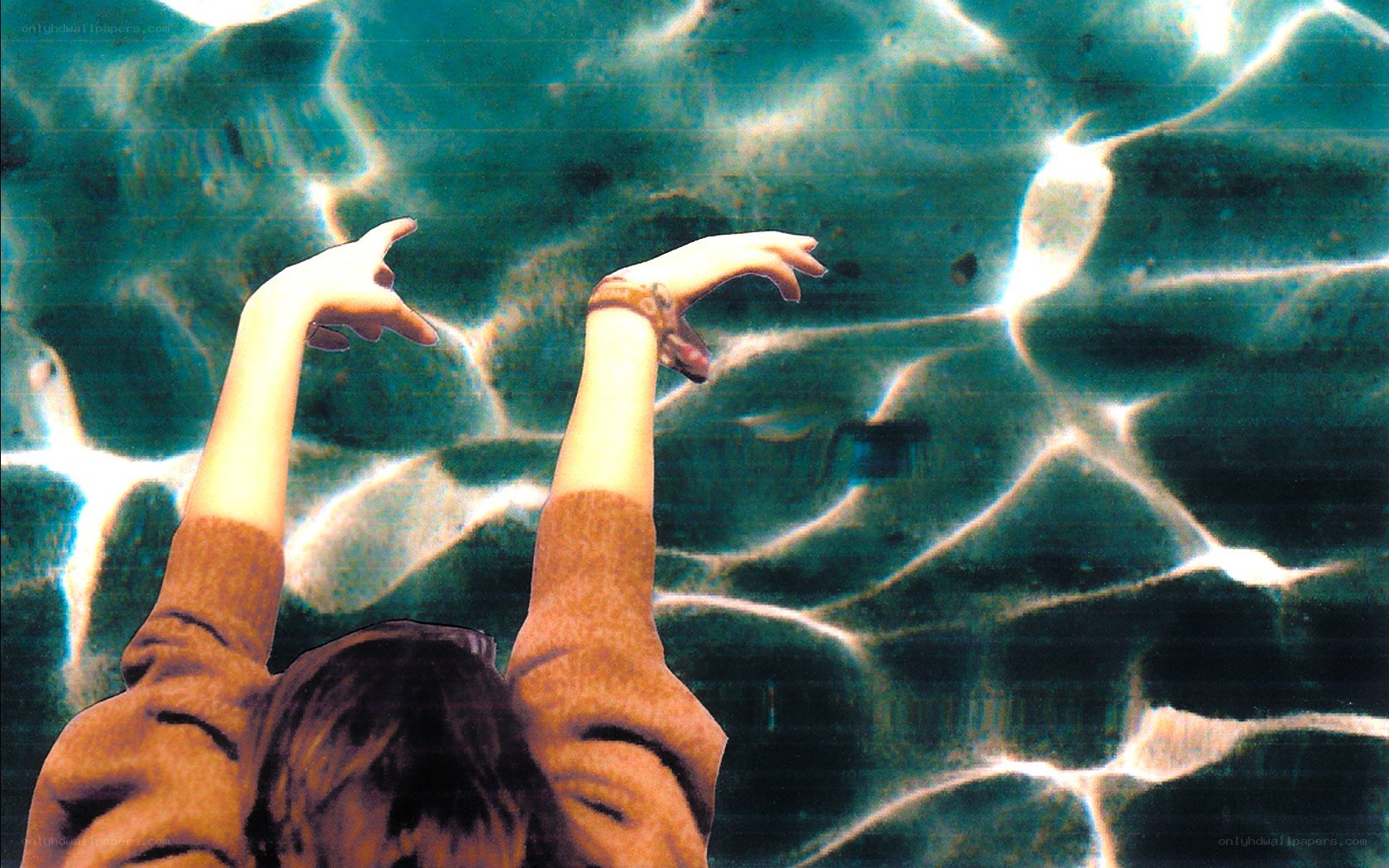 person reaching up underwater