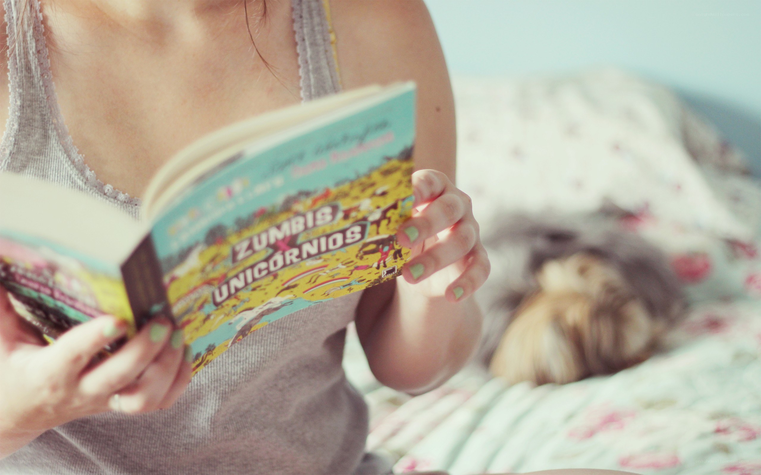 person reading book in bed
