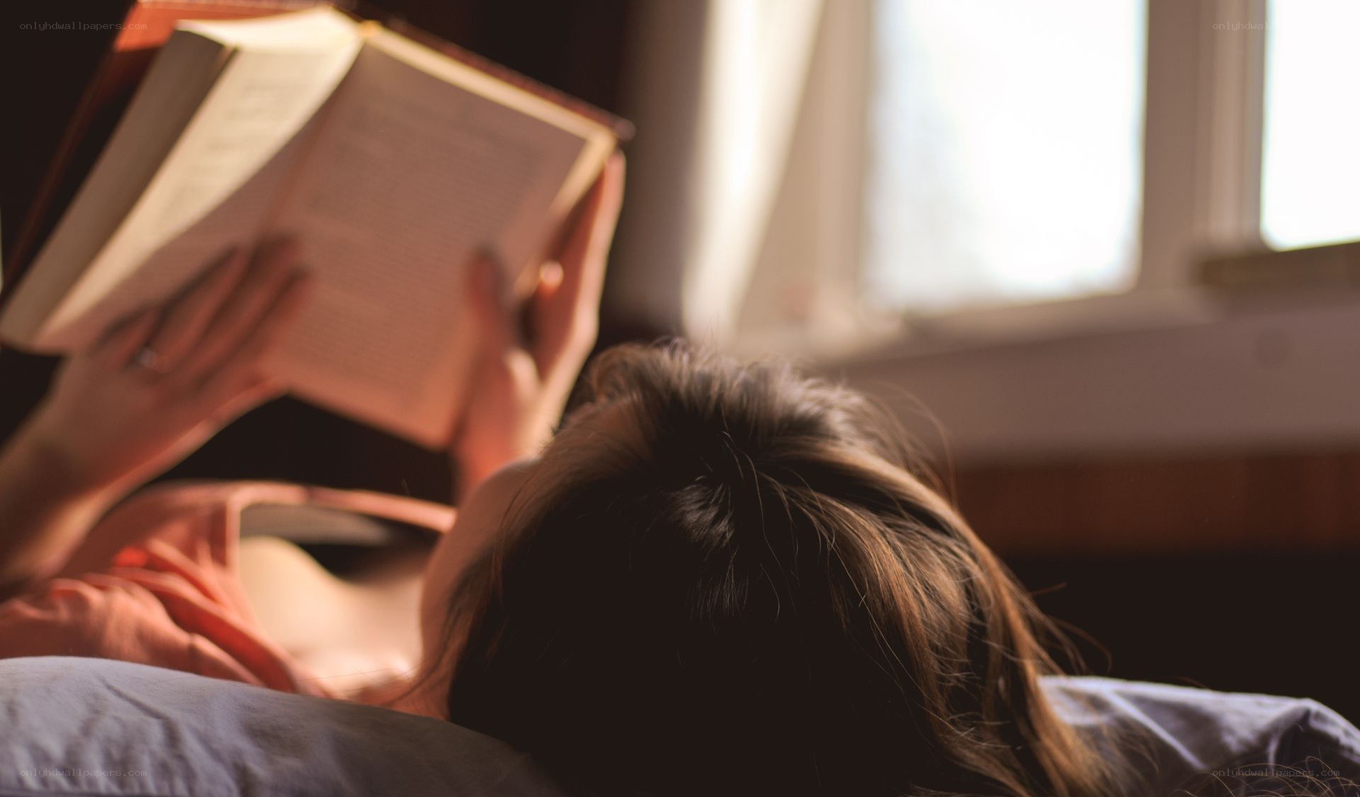 person reading book in bed