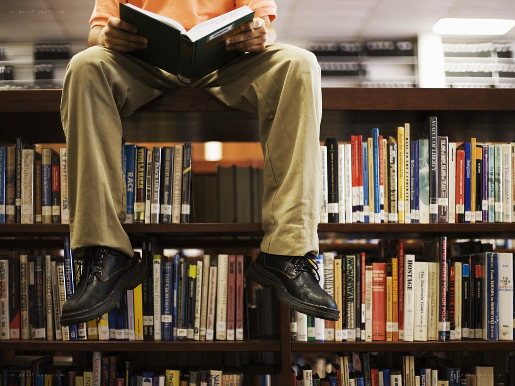 Person reading book in library