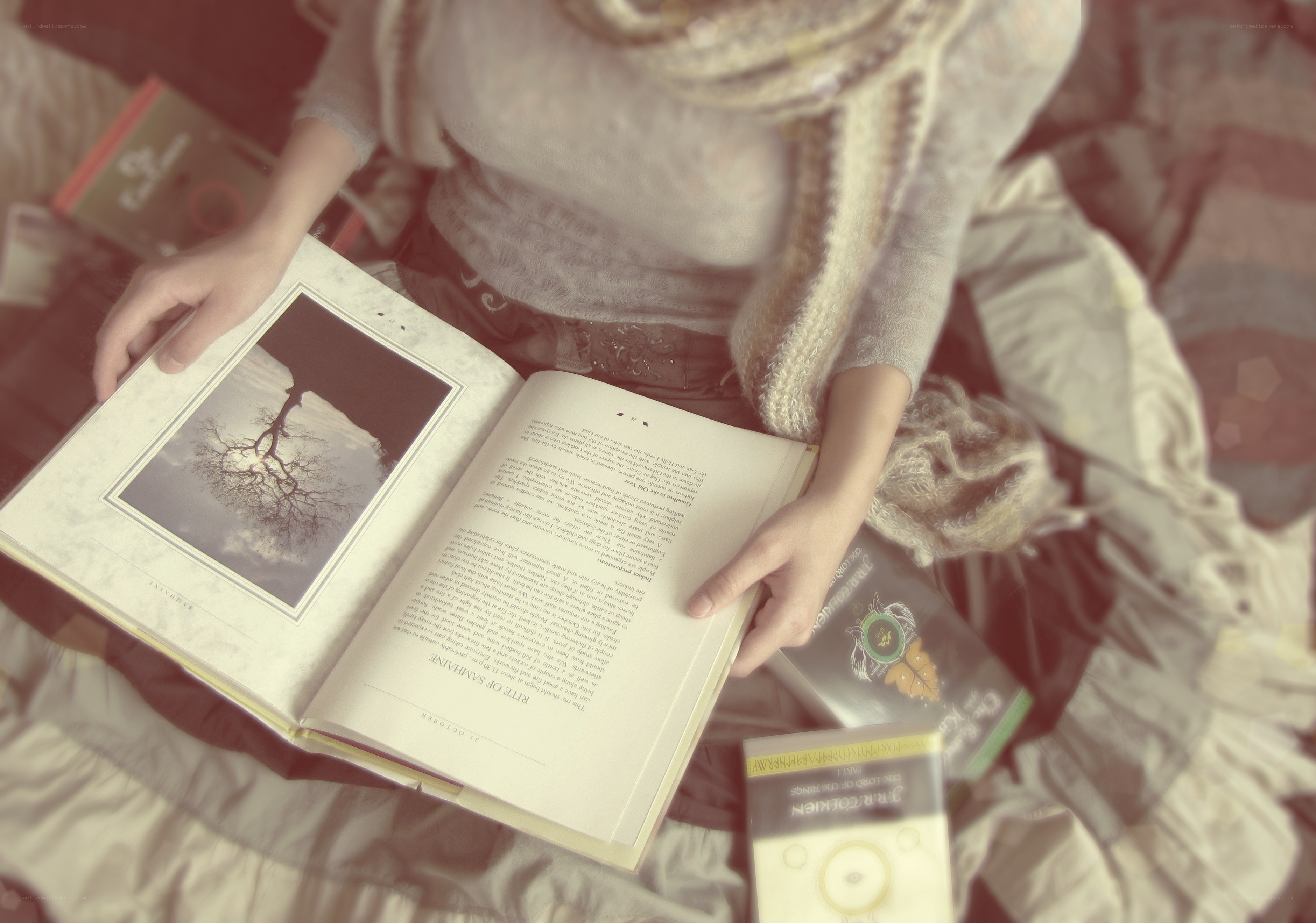 person reading book on bed