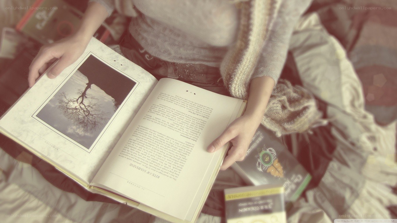 person reading book on bed