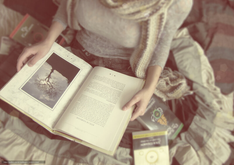 person reading book on bed