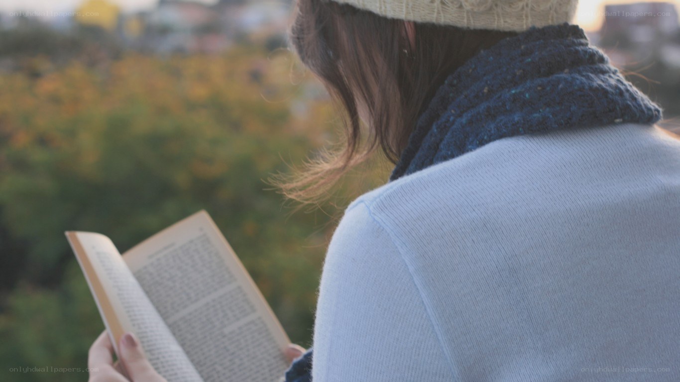 person reading book outdoors