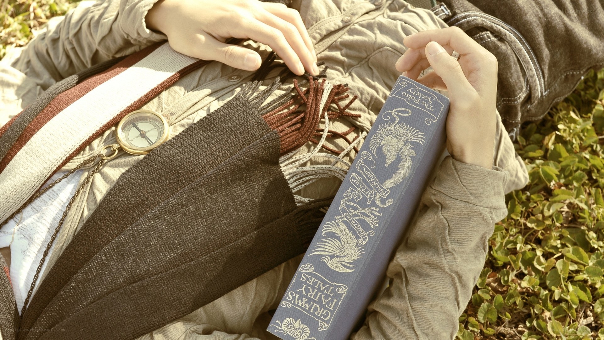 person reading book outdoors