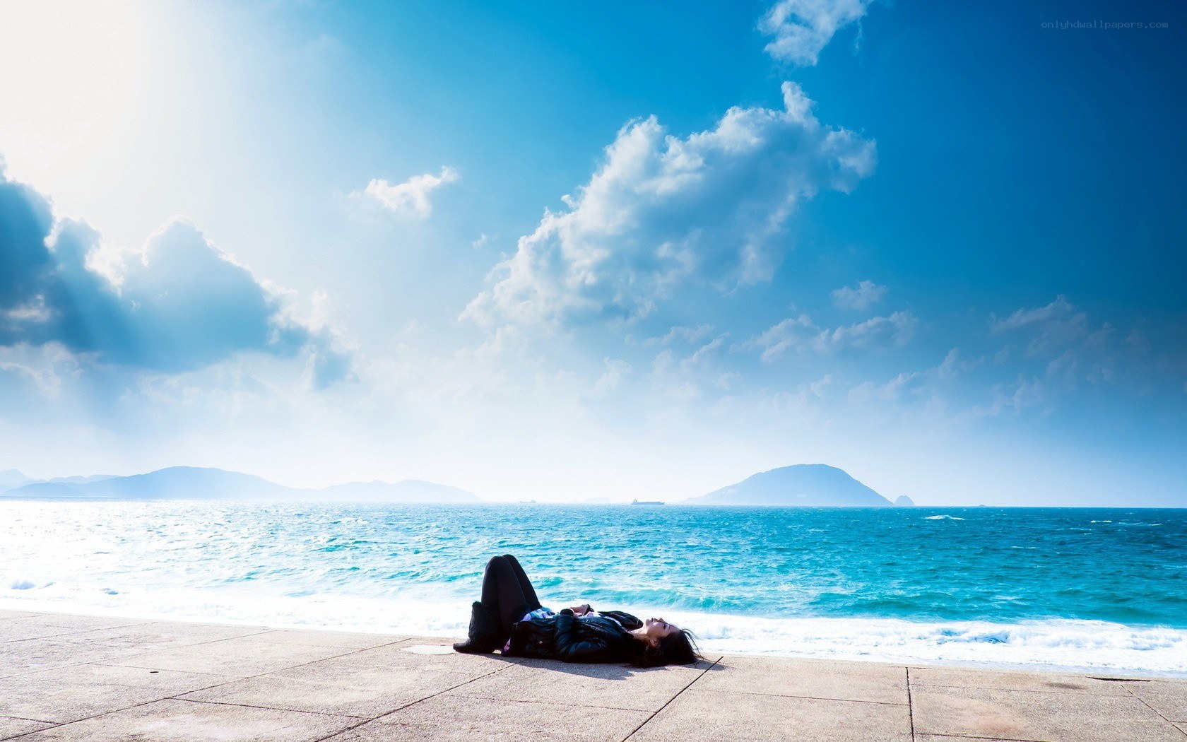 Person relaxing on a pier