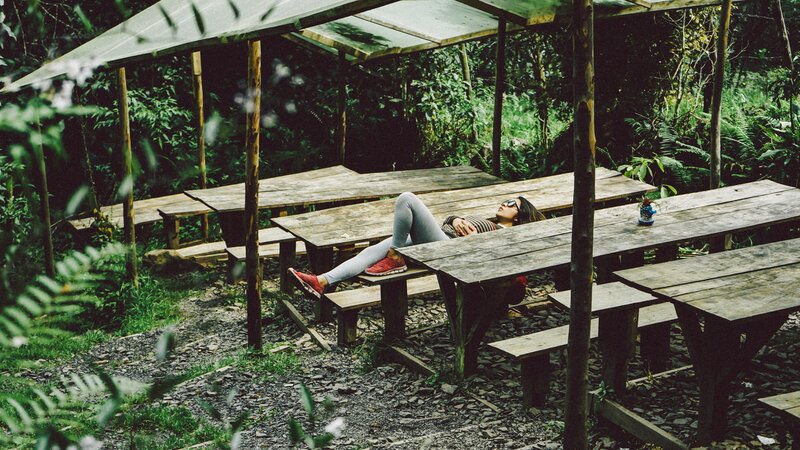 Person resting at picnic table