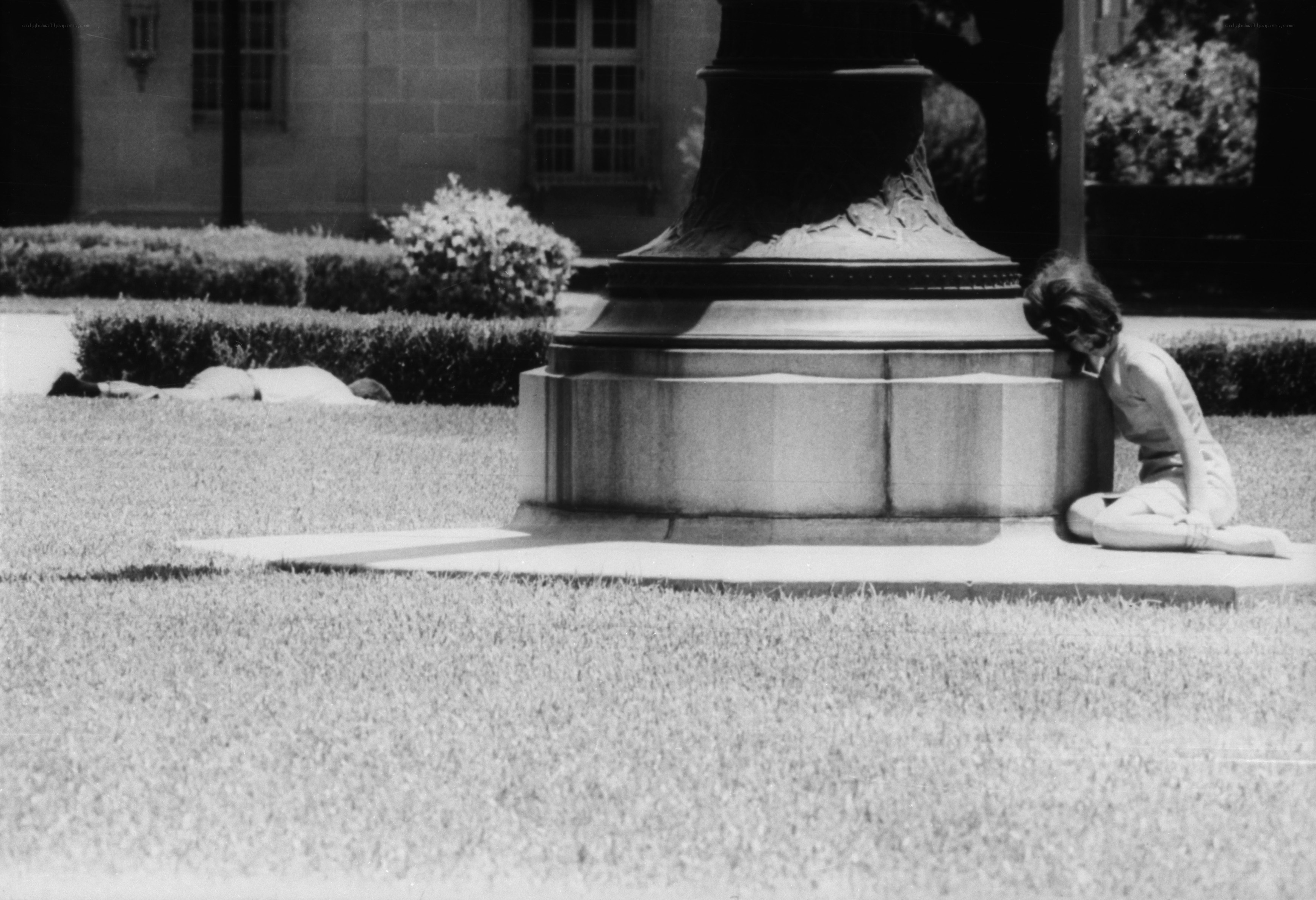 Person resting by a monument