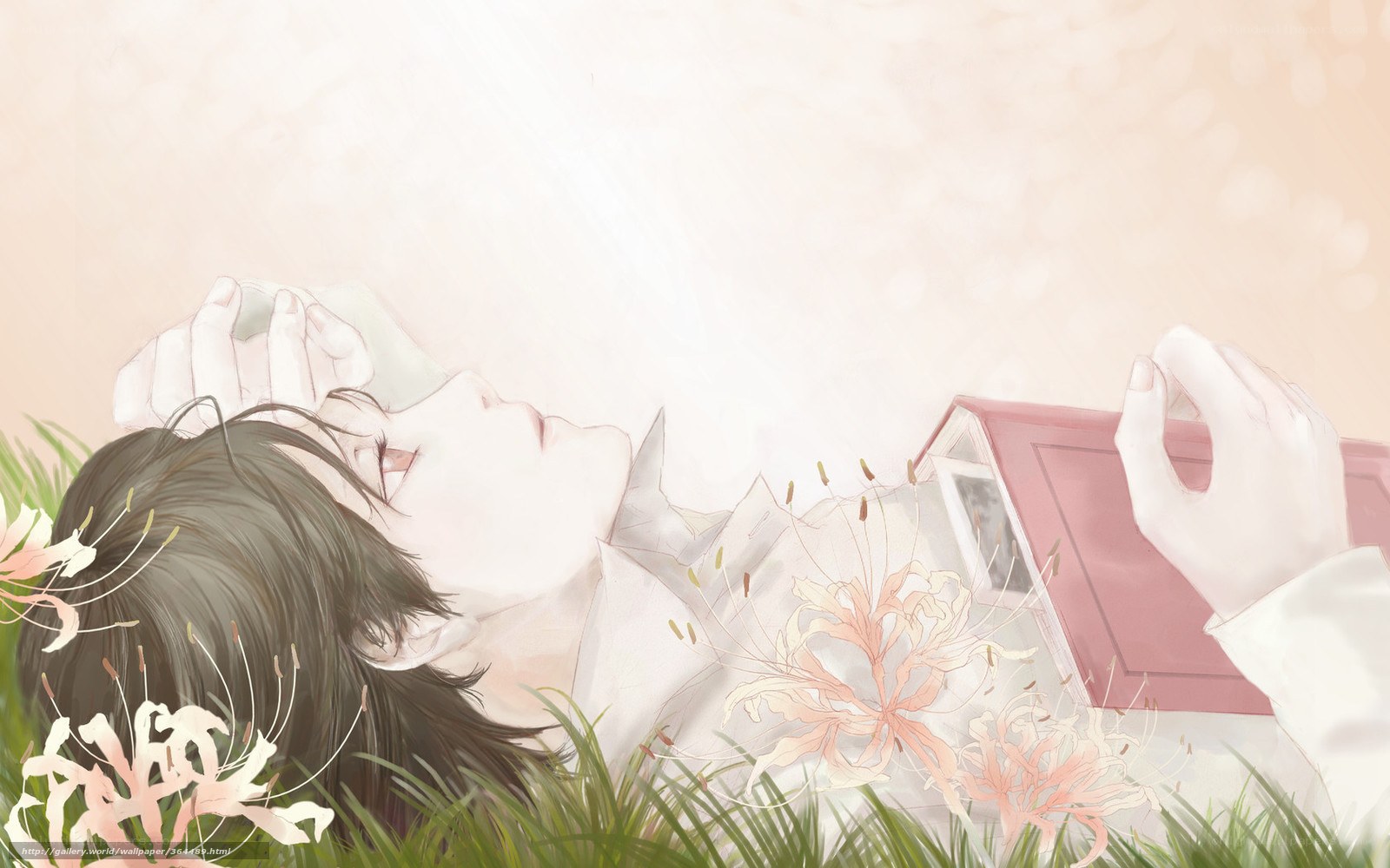 Person resting in grass with book