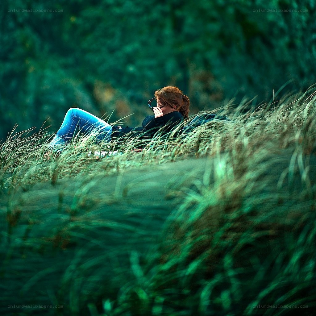 Person resting in tall grass