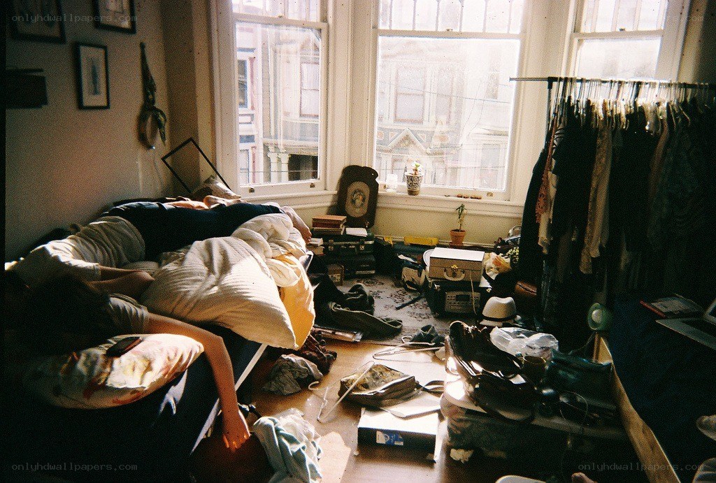 Person resting on a messy couch