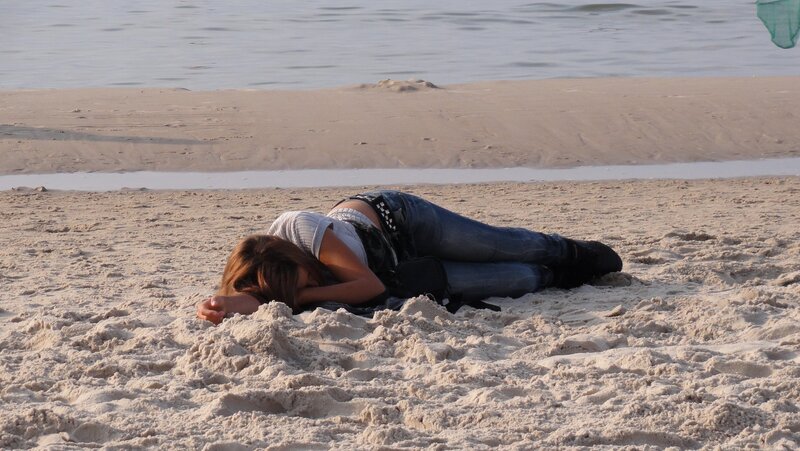 Person resting on beach